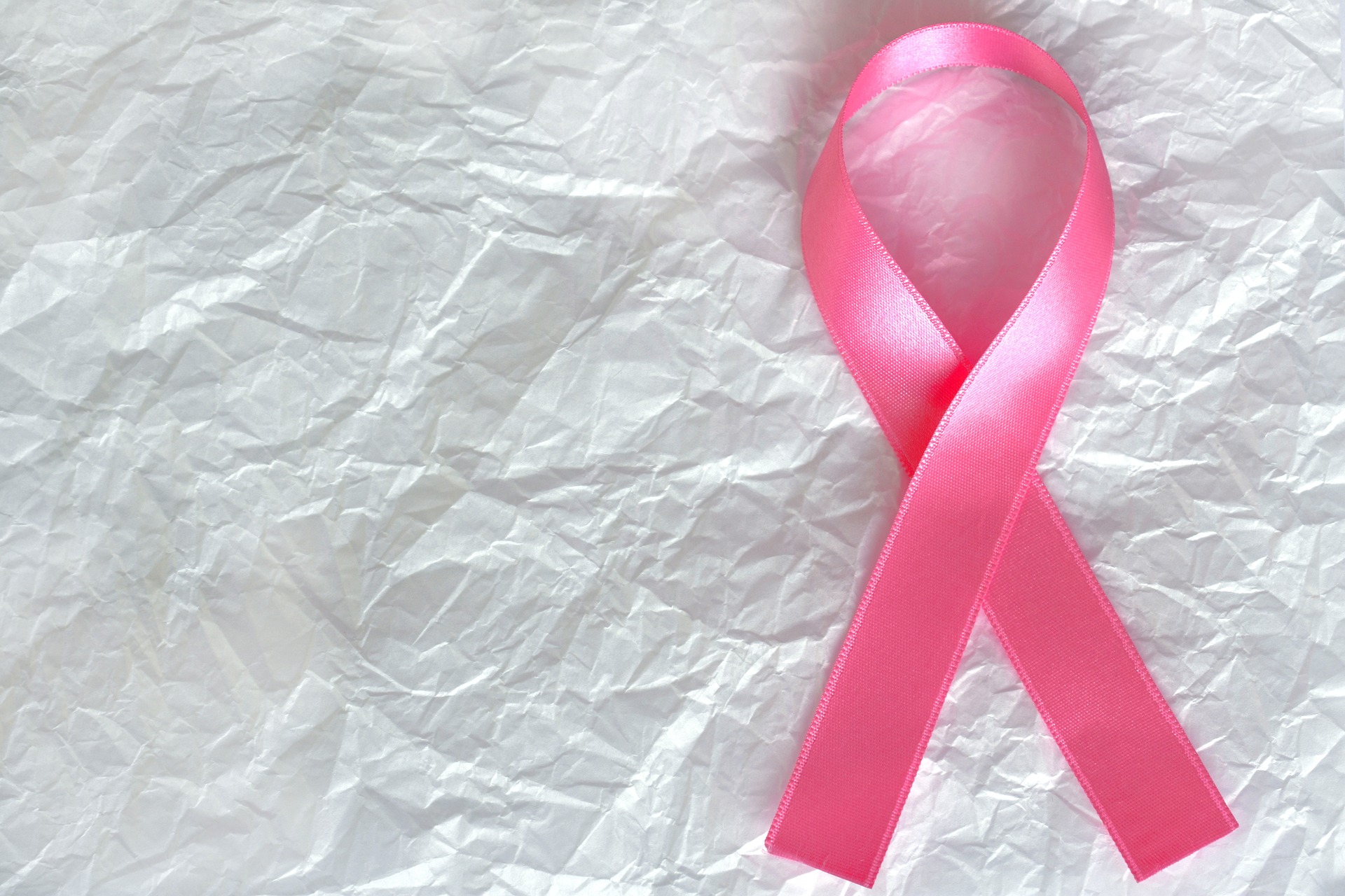Pink ribbon for breast cancer awareness. Facts about breastfeeding and breast cancer. 