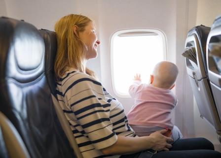 Mom with baby on airplane. Tips for air travel for nursing moms.