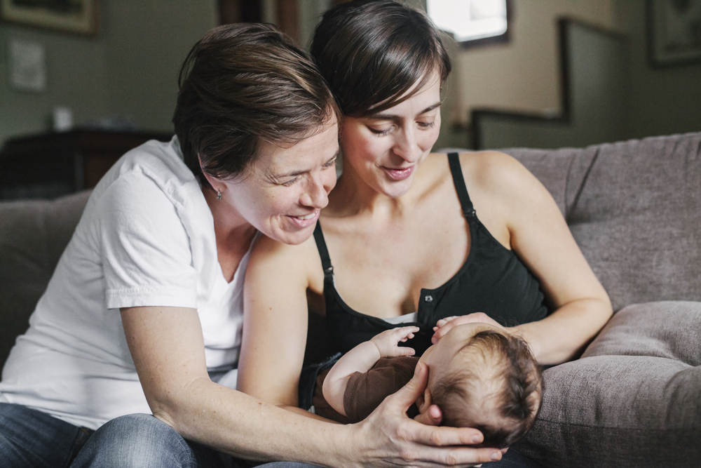 A same-sex couple with an infant. Learn how to improve LGBTQIA communications in your practice.