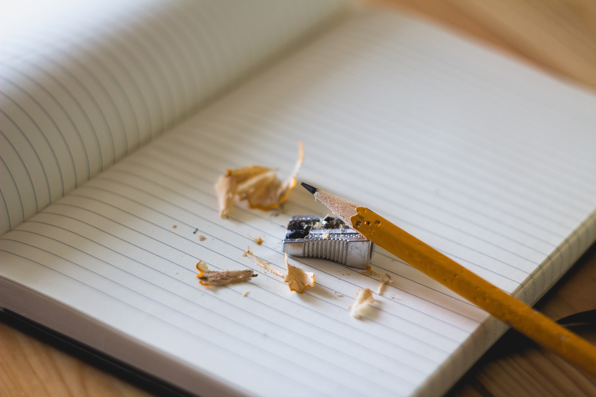 A newly sharpened pencil and new notebook.