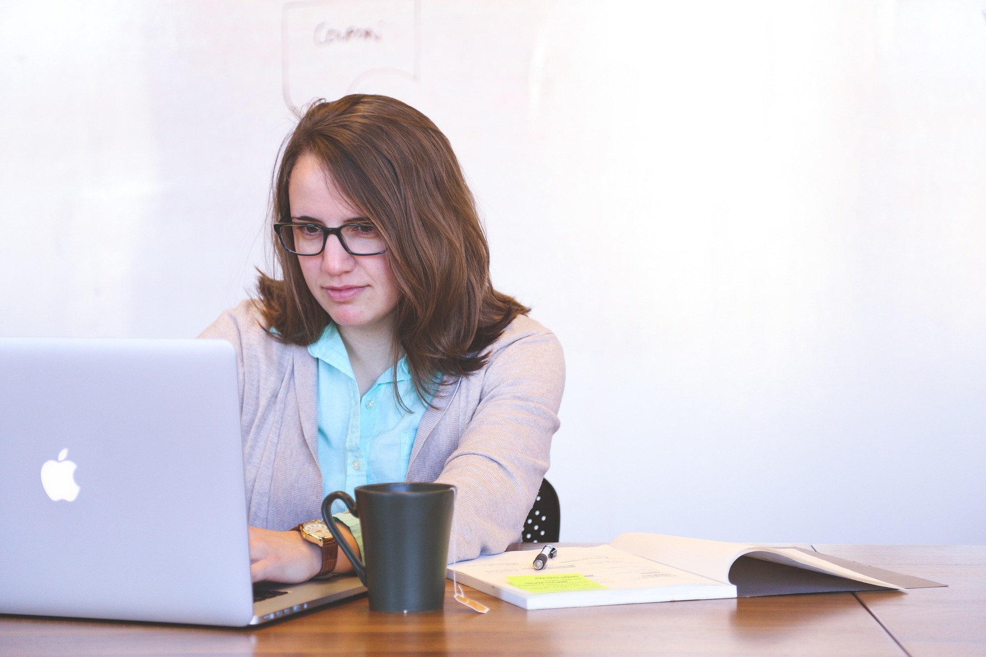 Woman at computer with cup of tea