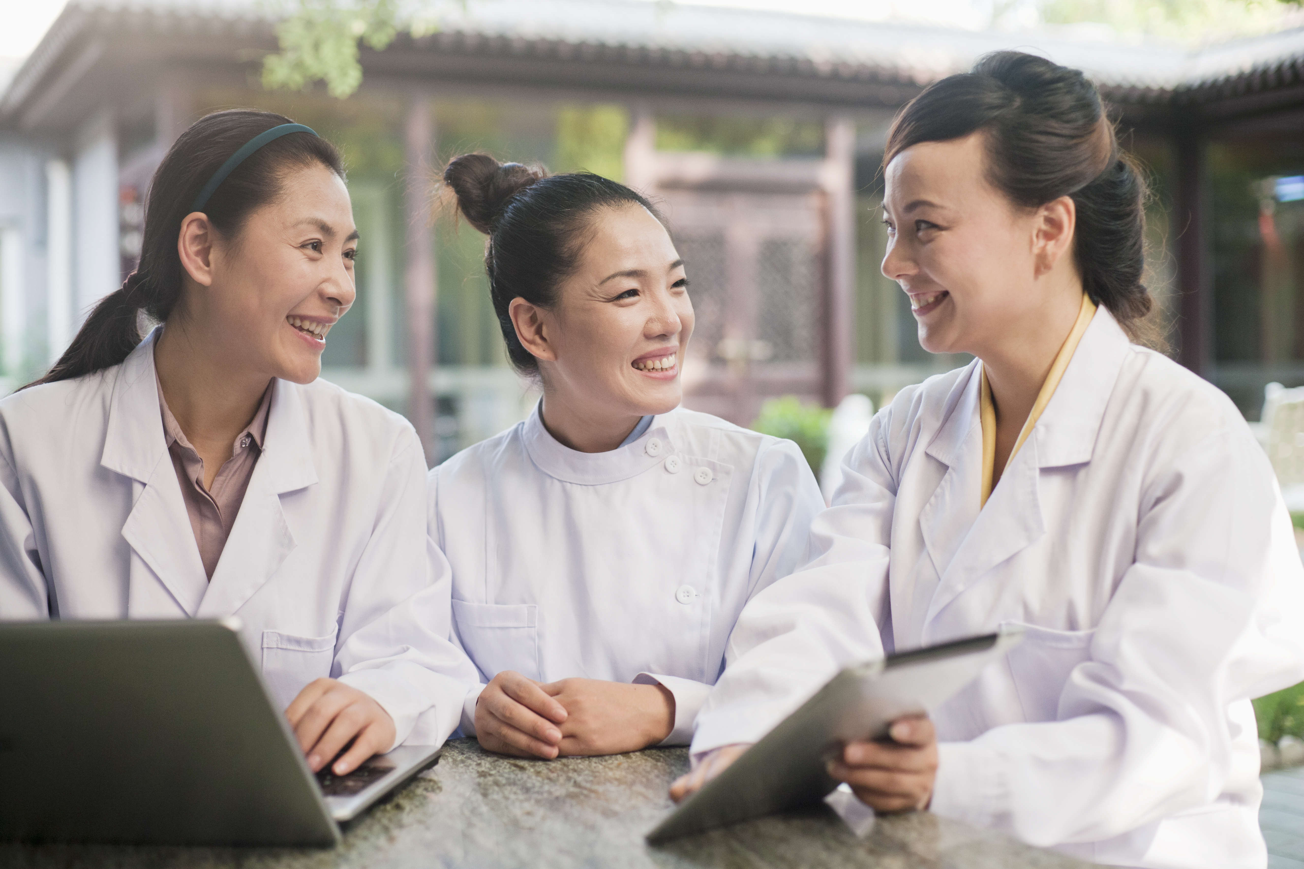 Three smiling staff members communicating  breastfeeding policy at a hospital.