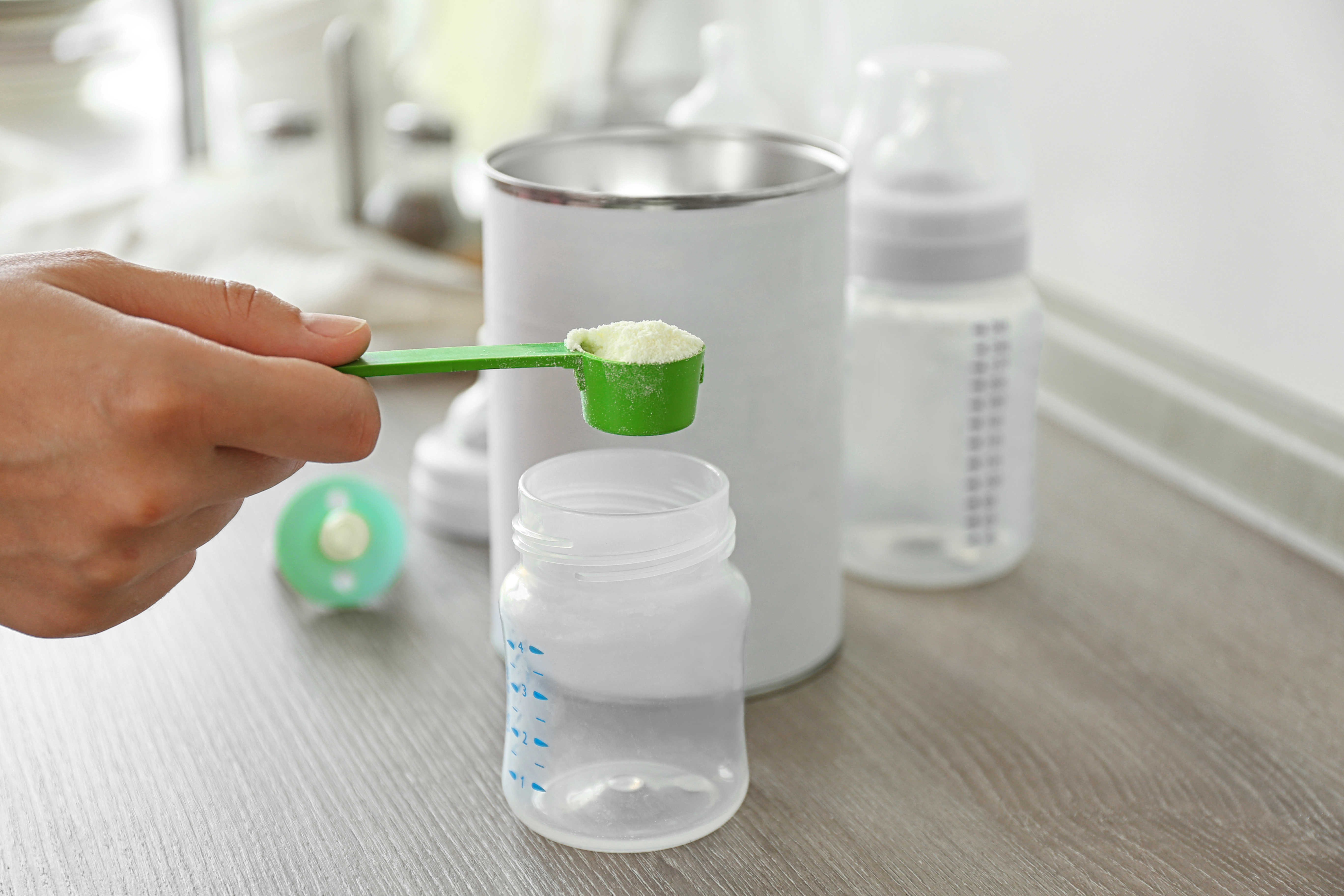 Formula measuring spoon, bottle, and can.