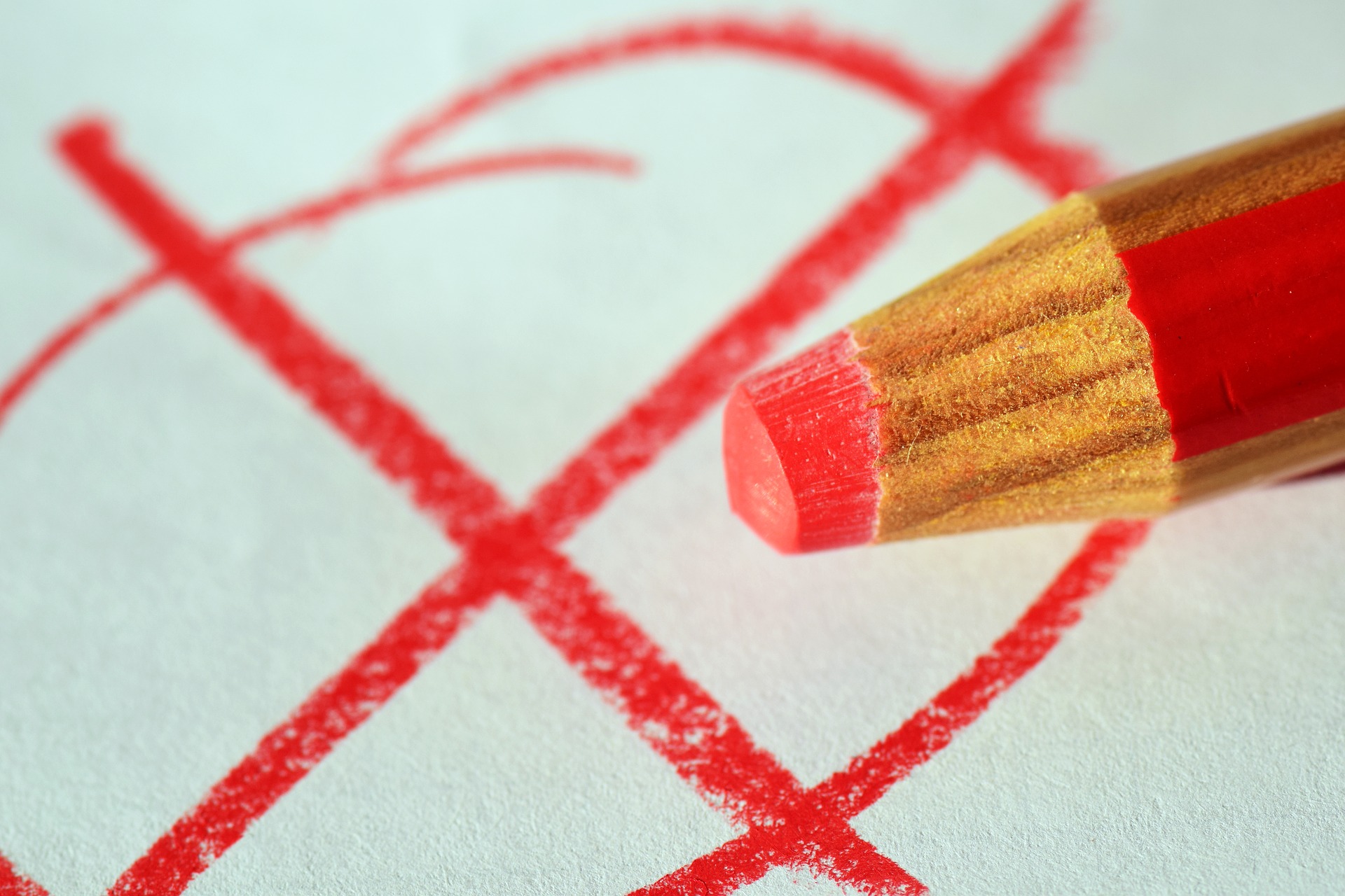 Red pencil marking an X over items that do not belong in a functional policy.