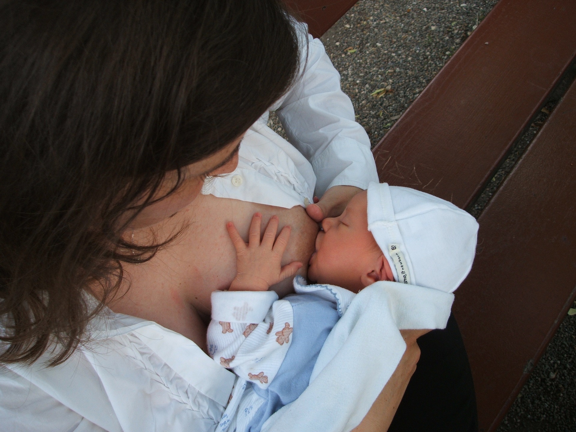 Mother feeding her child human milk,