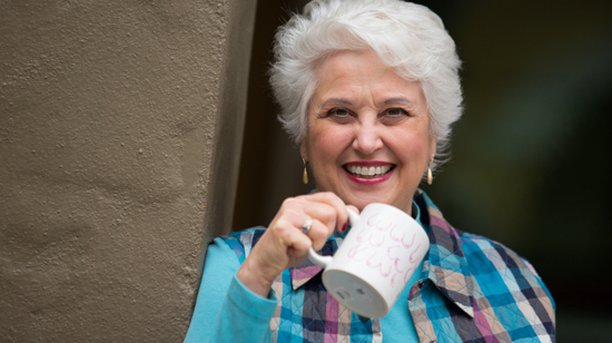 Picture of Marie Biancuzzo holding a mug, smiling. 