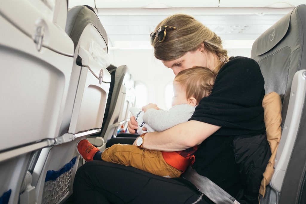 Mother with child during air travel