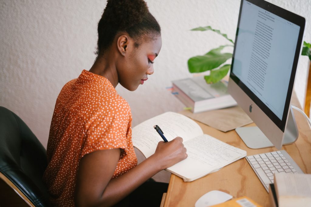 Woman studying in front of a computer screen.