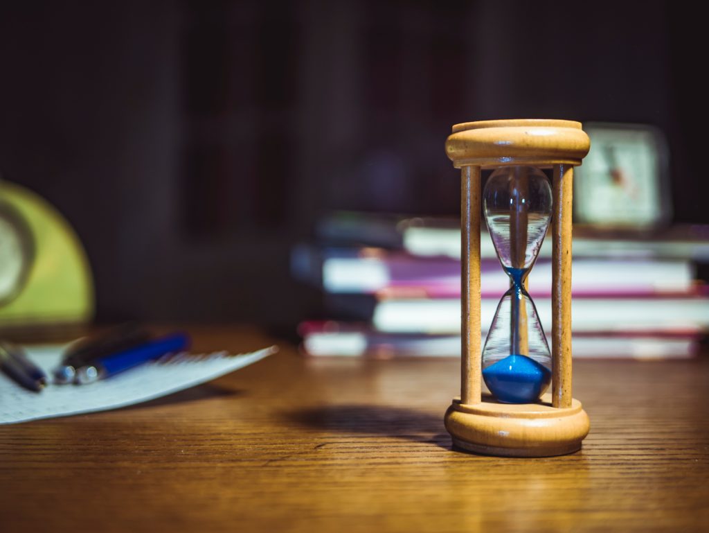 Hourglass with study materials