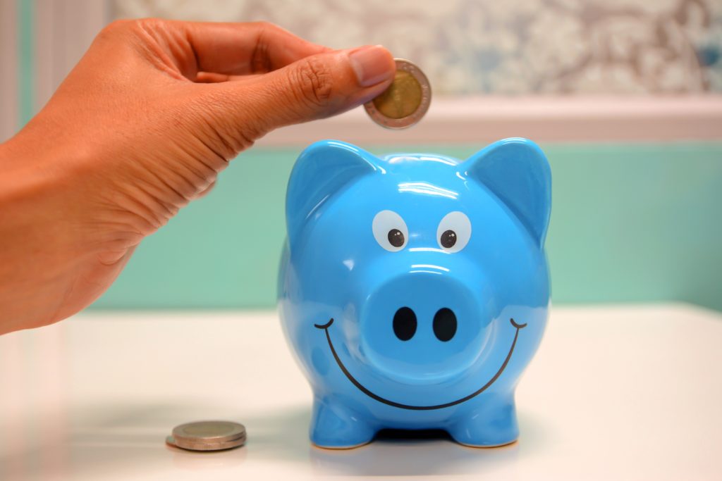 Lactation consultant adding money to a piggy bank
