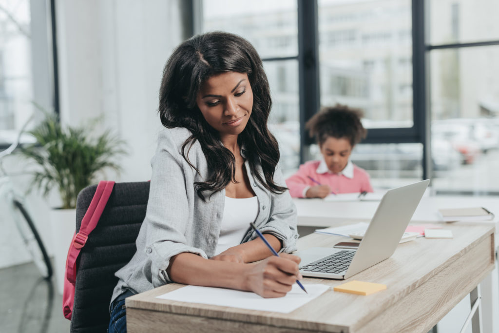 Mom and daughter studying together. 