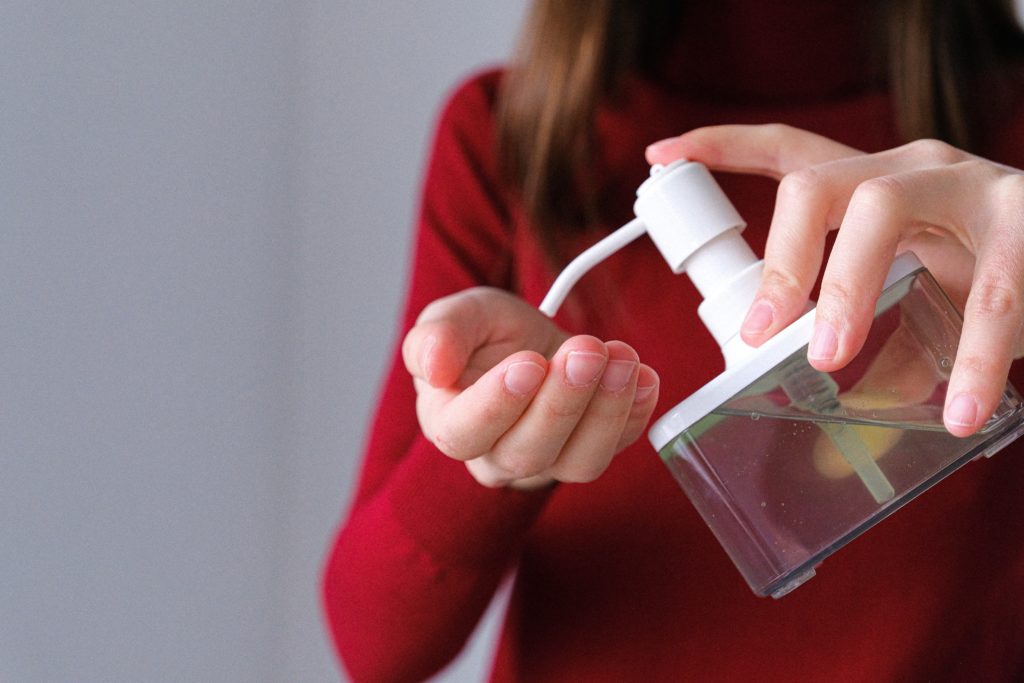 Woman applying soap to prevent spread of coronavirus.