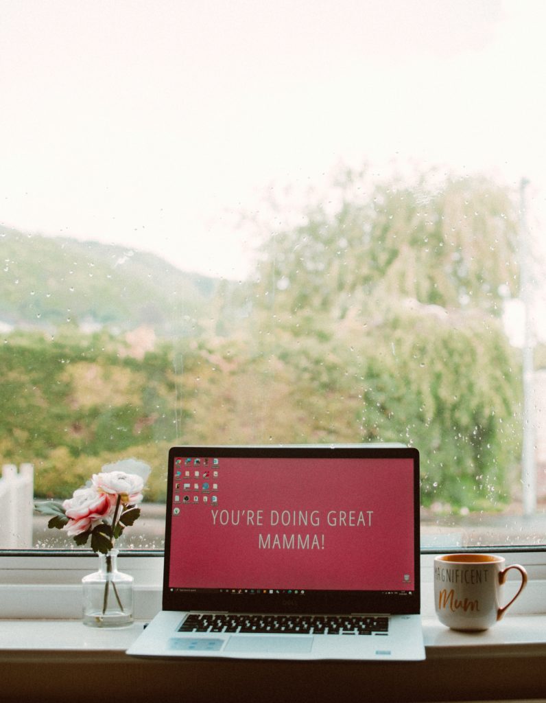 Laptop with "You're Doing Great Mamma!" on the screen