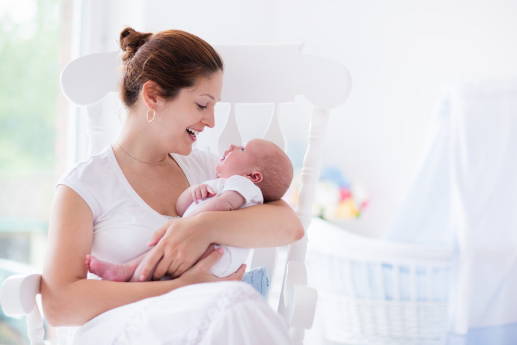 Mom in white shirt gazing at baby