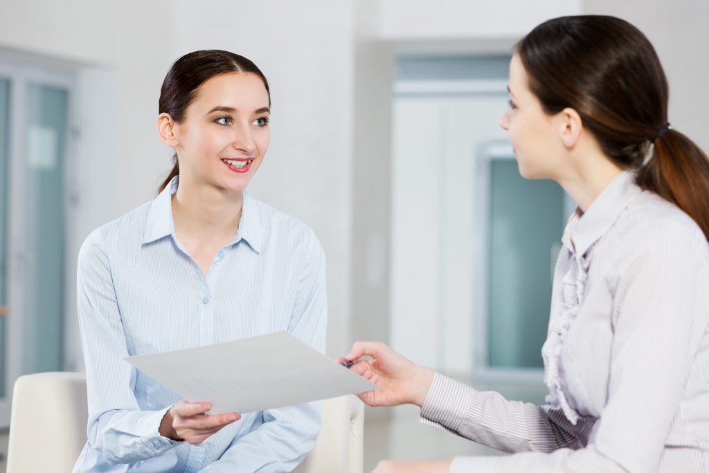 Women engaged in basic communication.