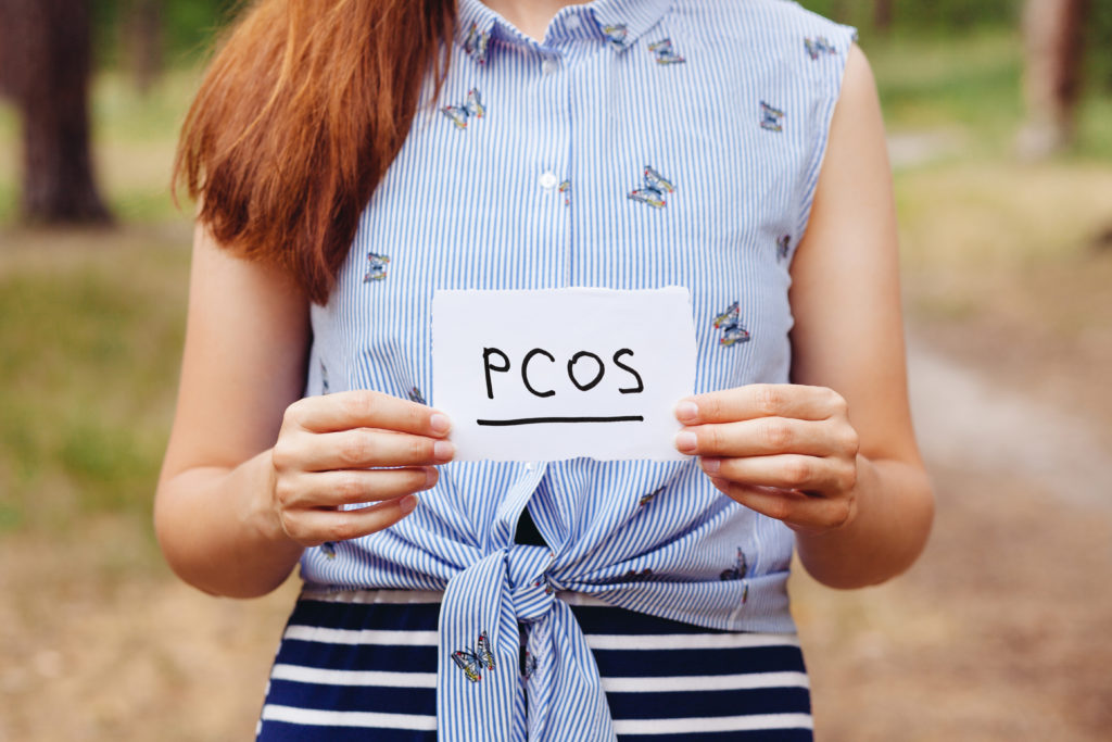 Woman holding PCOS sign