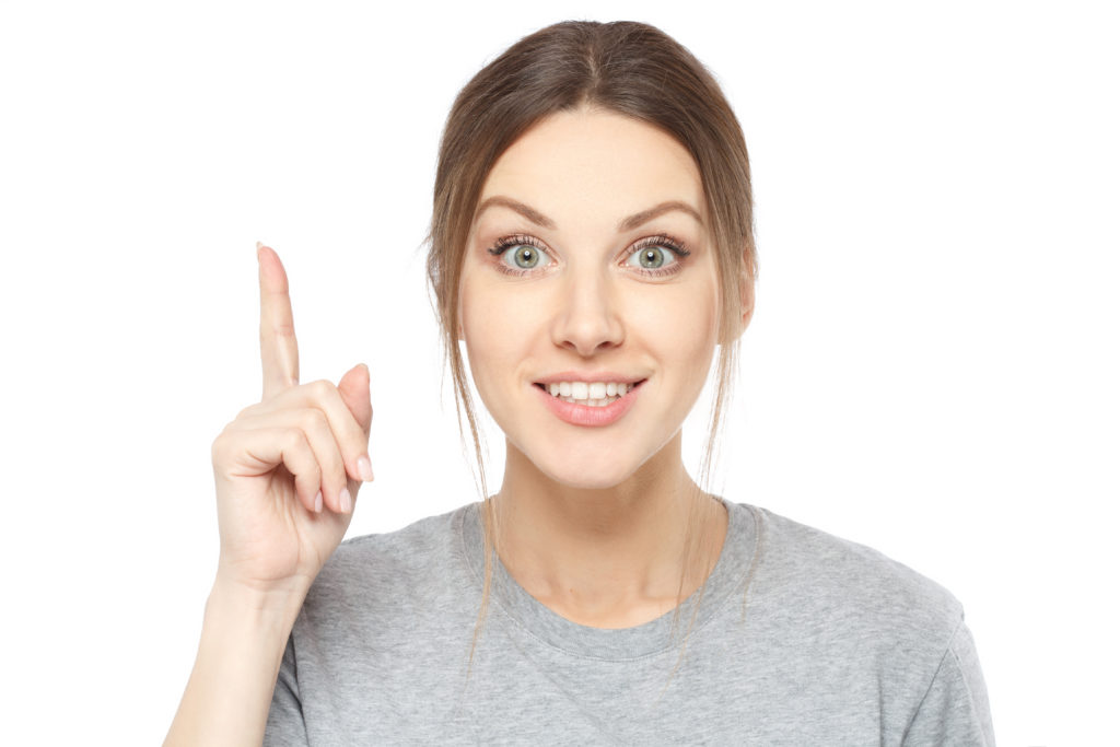 Woman with a pointed finger with the secret of getting the right answer on application-level questions.