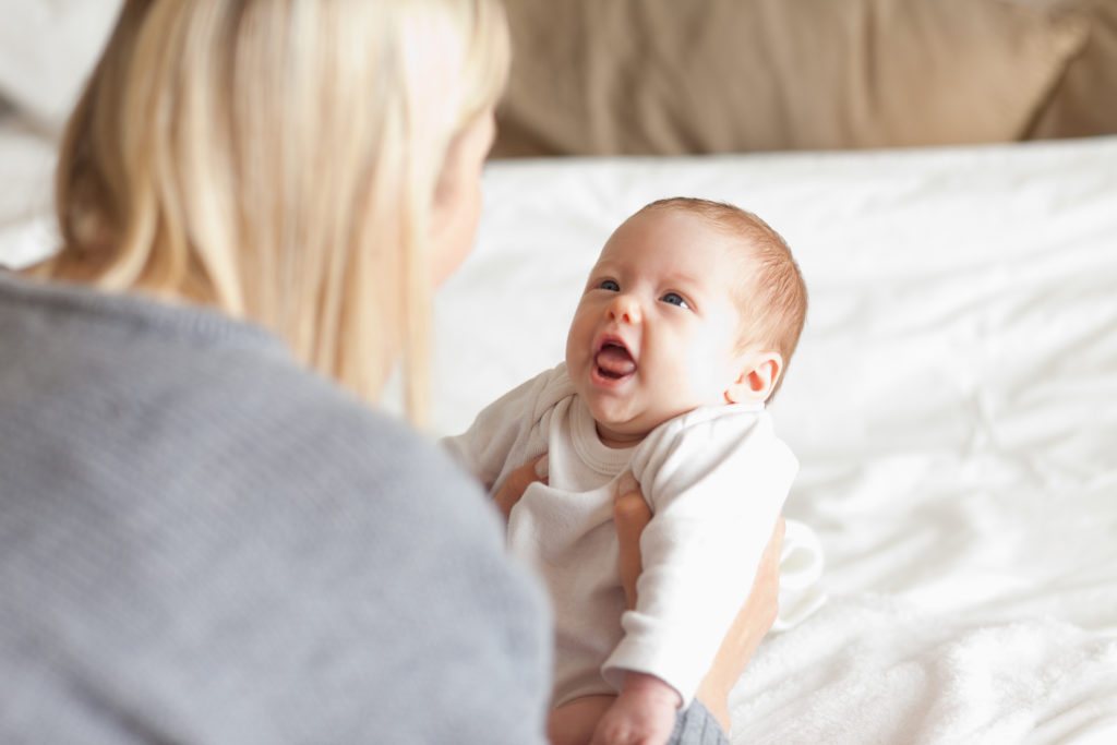 Blonde woman holding young infant.