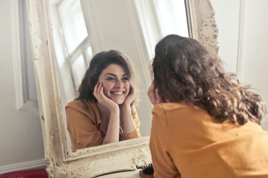 Woman looking into the mirror during self-talk