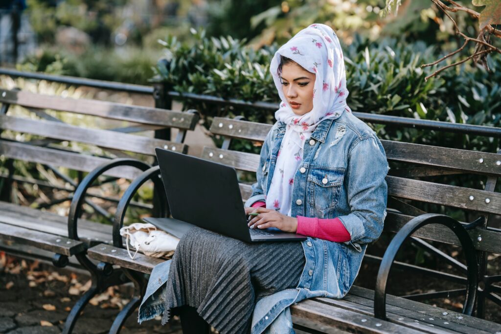 Woman sitting on bench considering options to study for IBLCE exam.