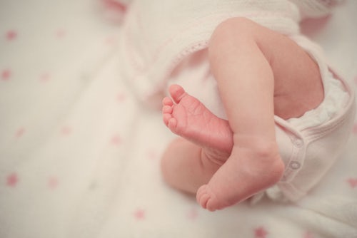 Close up of newborn feet and legs