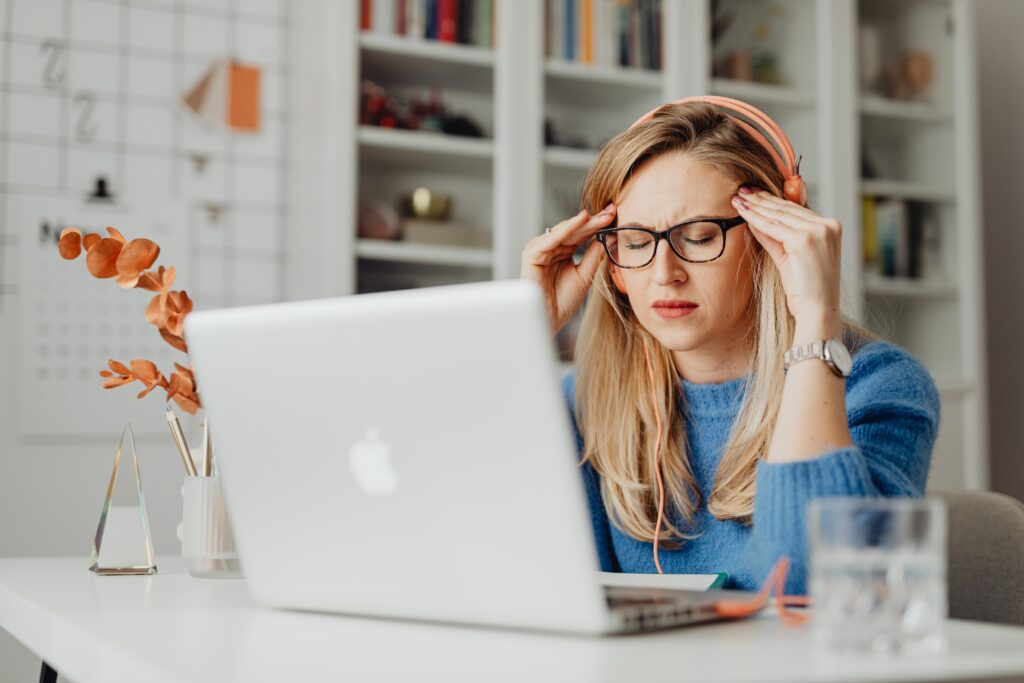 Woman at a laptop computer dealing with test anxiety.