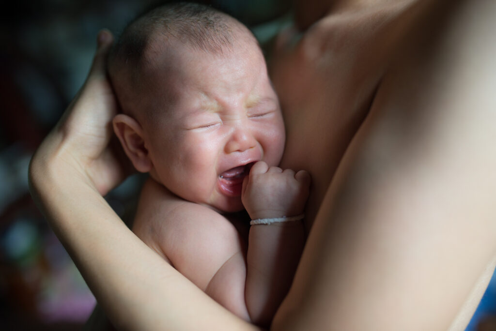 Newborn baby crying and refusing to breastfeed.