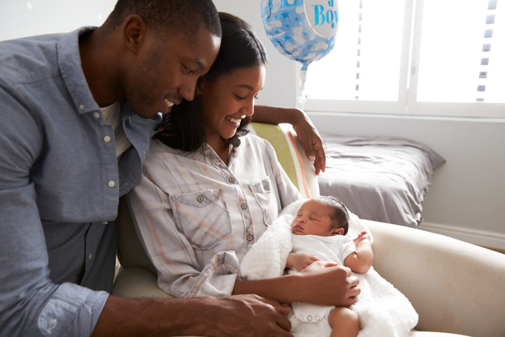 Black couple with newborn infant in the hospital prior to discharge.