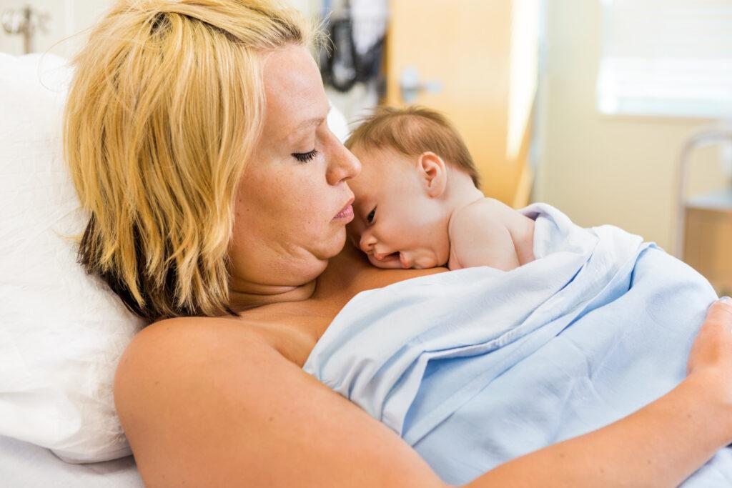 Mom with baby practicing skin-to-skin newborn contact.