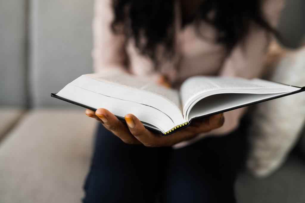 Woman holding book full of terminology.